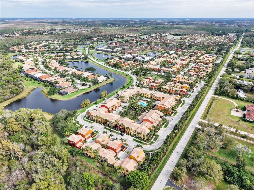 Aerial view of property and surrounding area featuring a large body of water and nearby suburban area