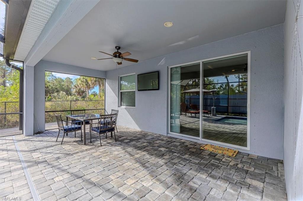 View of patio with outdoor dining space and ceiling fan