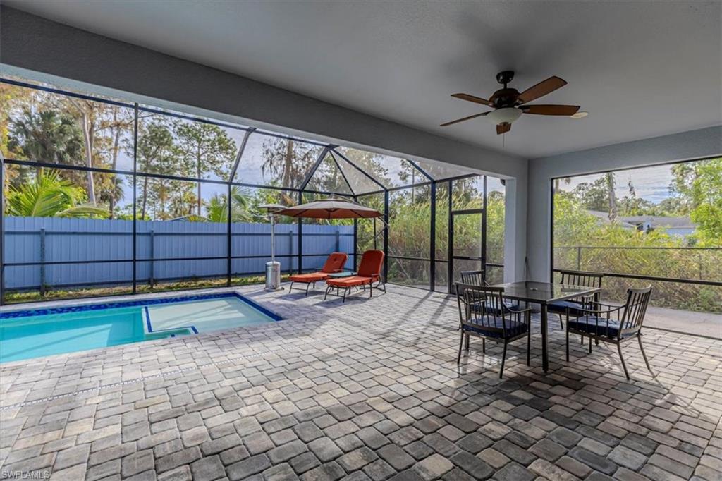 View of pool with a patio area, outdoor dining area, a lanai, and a sunroom