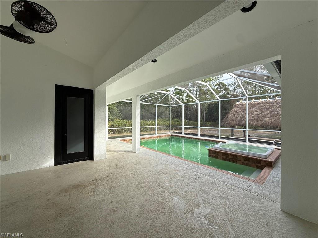 View of swimming pool with a sunroom, a patio, a lanai, and a pool with connected hot tub