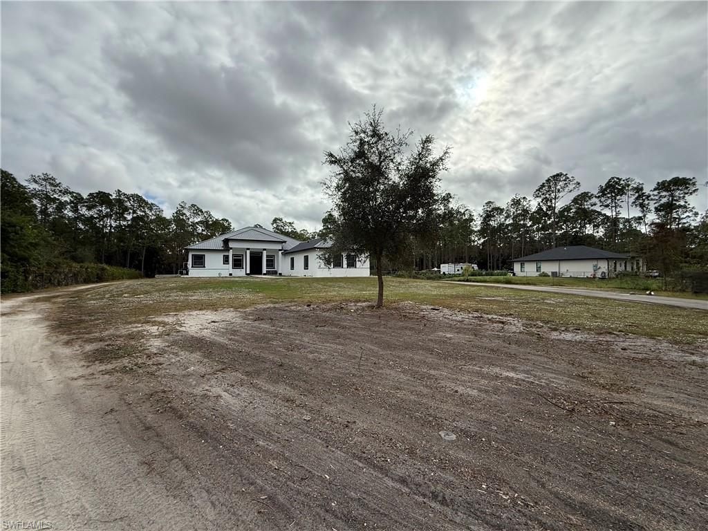 Single story home featuring a front lawn