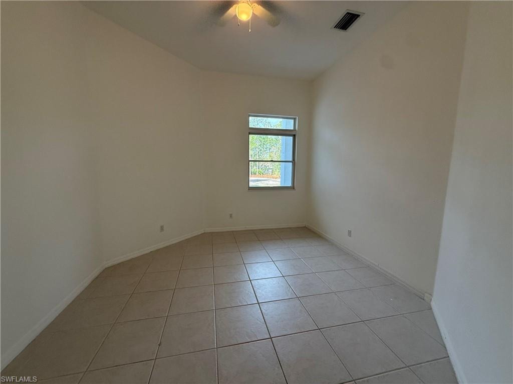 Unfurnished room with light tile patterned flooring and a ceiling fan