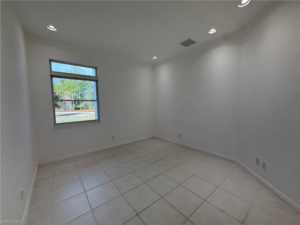 Unfurnished room featuring light tile patterned flooring and recessed lighting