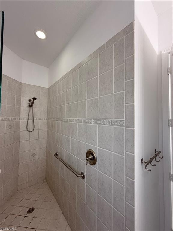 Bathroom featuring a tile shower and recessed lighting