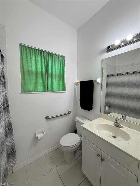 Full bath with curtained shower, vanity, and light tile patterned floors
