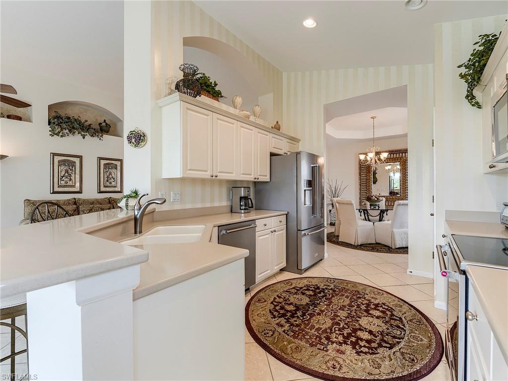 White cabinets and Corian countertops.  Wall accent is faux paint , not wallpaper
