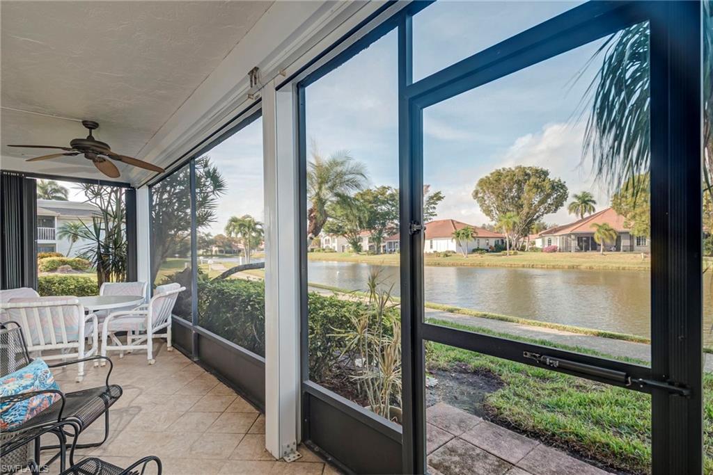 Sunroom / solarium with a water view and ceiling fan