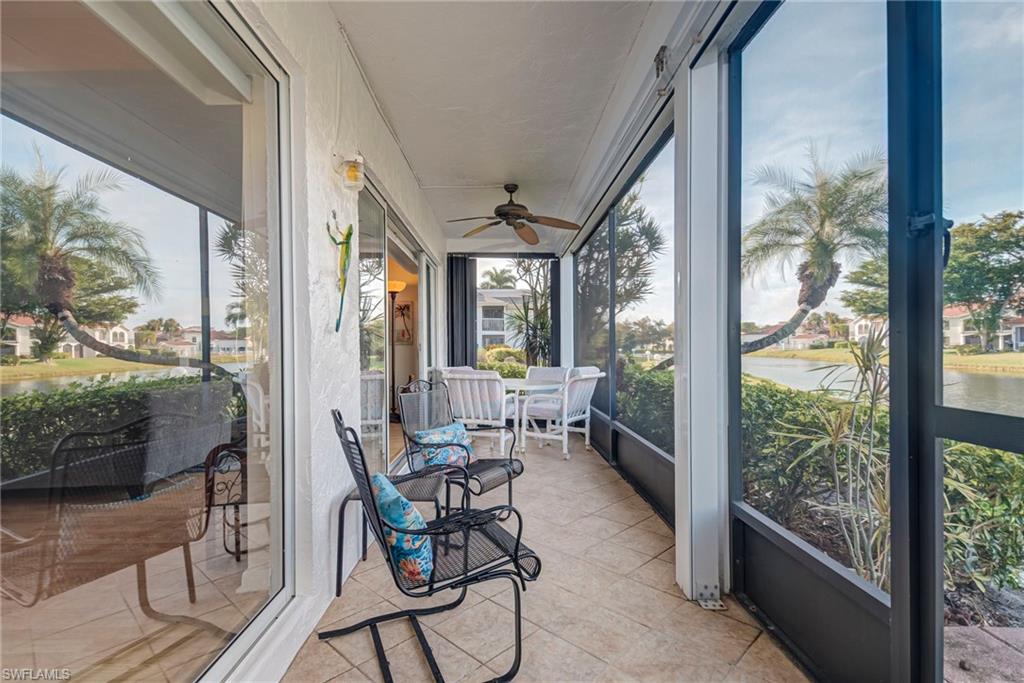 Sunroom with a water view and a ceiling fan
