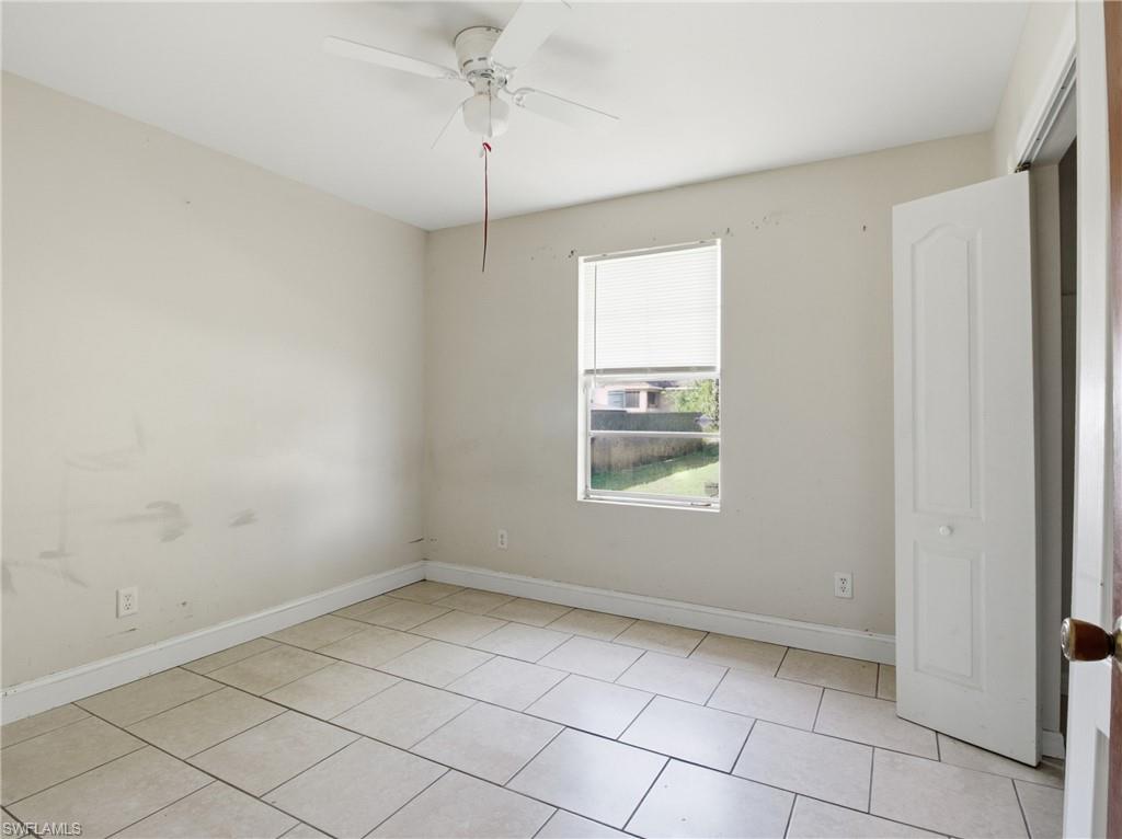 Unfurnished bedroom featuring ceiling fan and light tile patterned flooring
