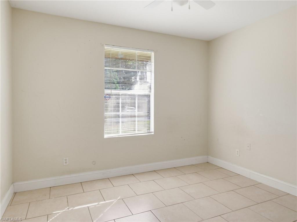 Spare room featuring ceiling fan and light tile patterned floors