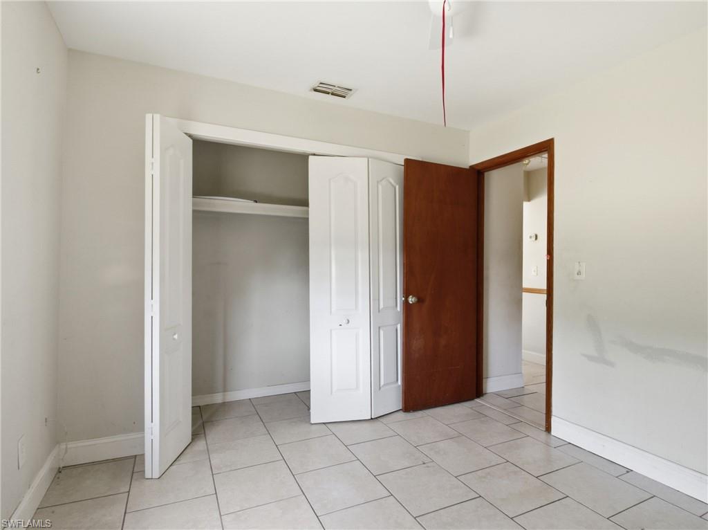 Unfurnished bedroom featuring a closet and light tile patterned floors