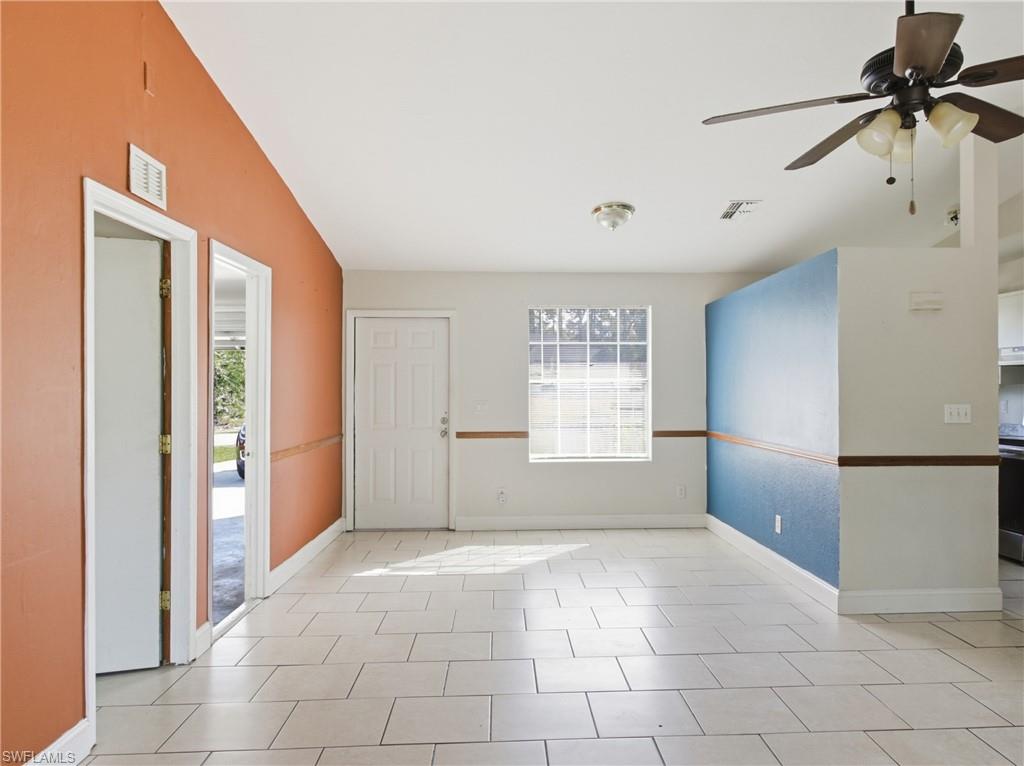 Spare room with ceiling fan and light tile patterned flooring