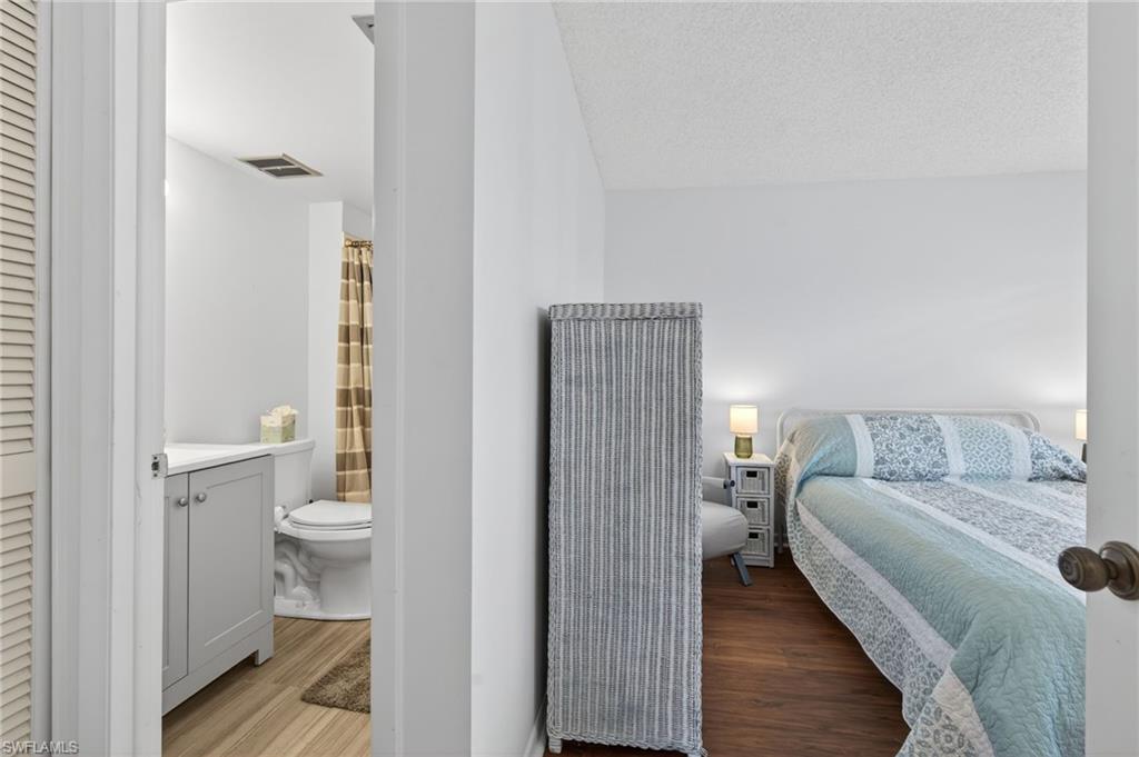 Bedroom featuring wood finished floors and a textured ceiling