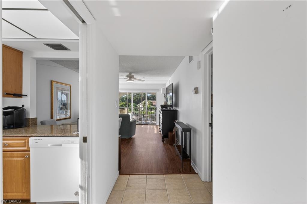 Corridor featuring light tile patterned floors
