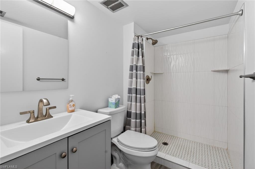 Bathroom featuring a stall shower and vanity