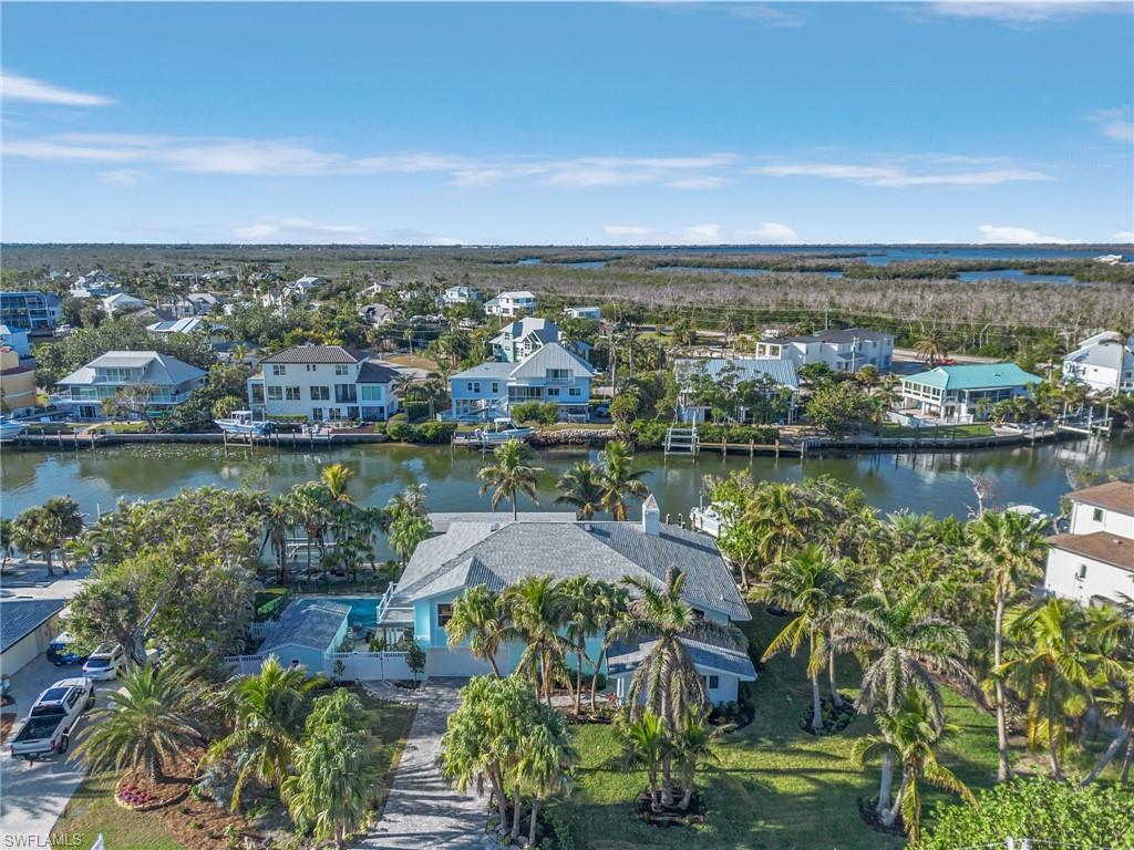 Aerial view of residential area featuring a nearby body of water