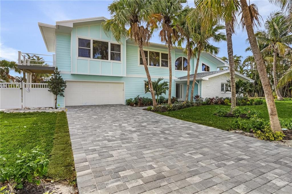 View of front facade with decorative driveway and an attached garage