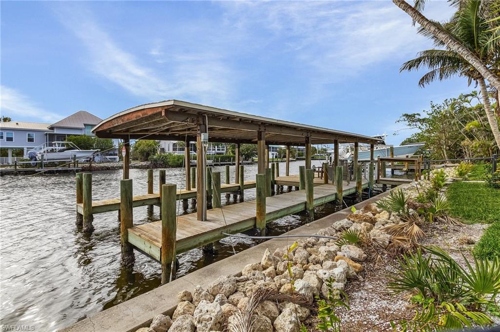 Dock area with a water view and boat lift