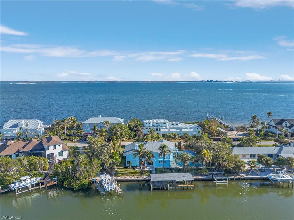 Aerial view of residential area featuring a large body of water
