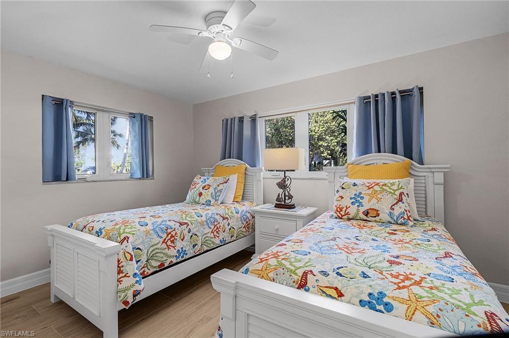 Bedroom with ceiling fan and wood tiled floors
