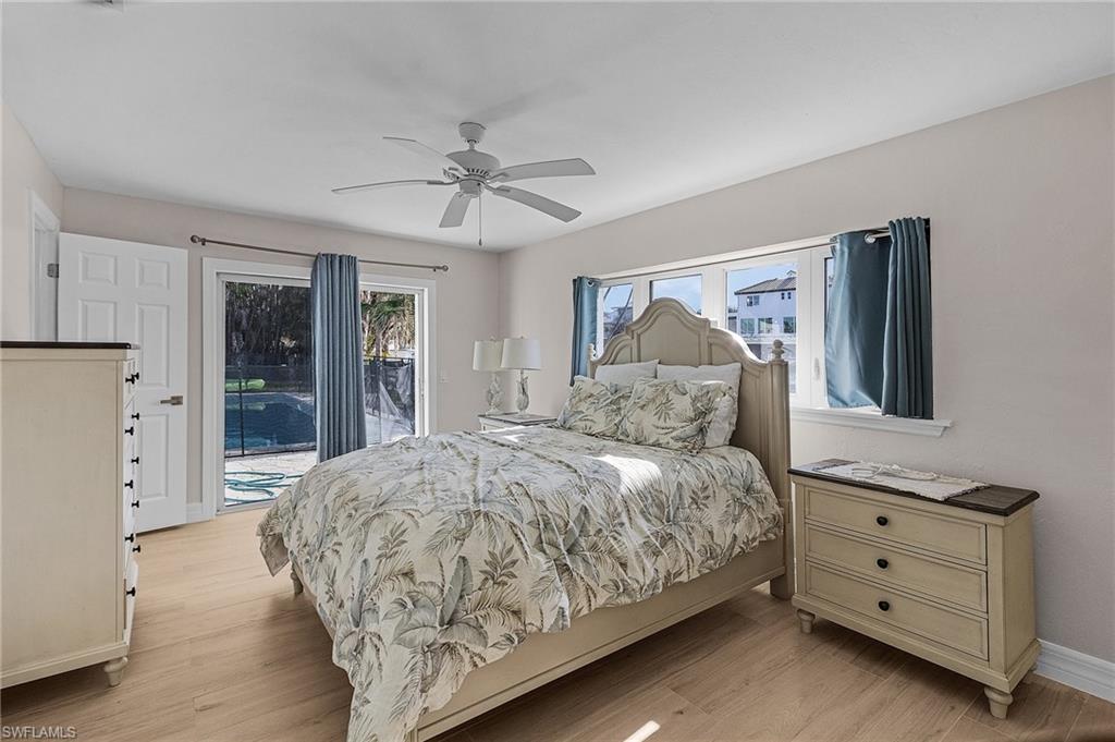 Bedroom featuring access to outside, light wood-type flooring, and a ceiling fan