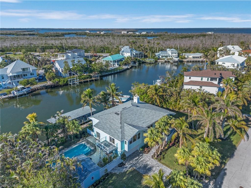 Aerial perspective of suburban area featuring a large body of water