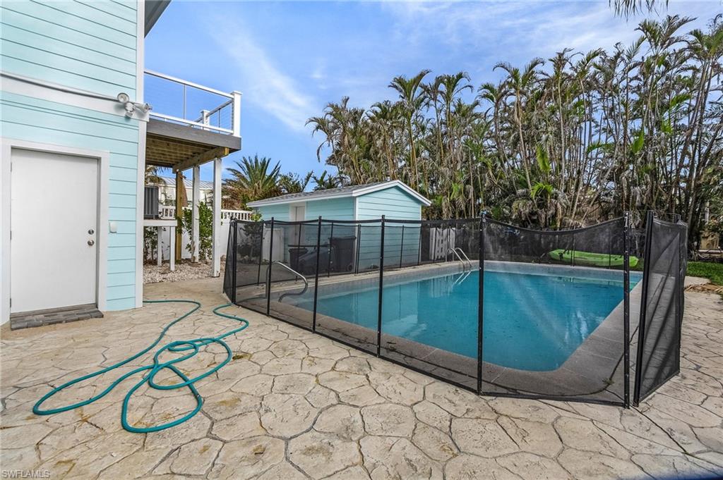 View of swimming pool with a patio and a balcony