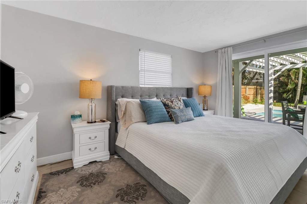 Tiled bedroom featuring access to exterior