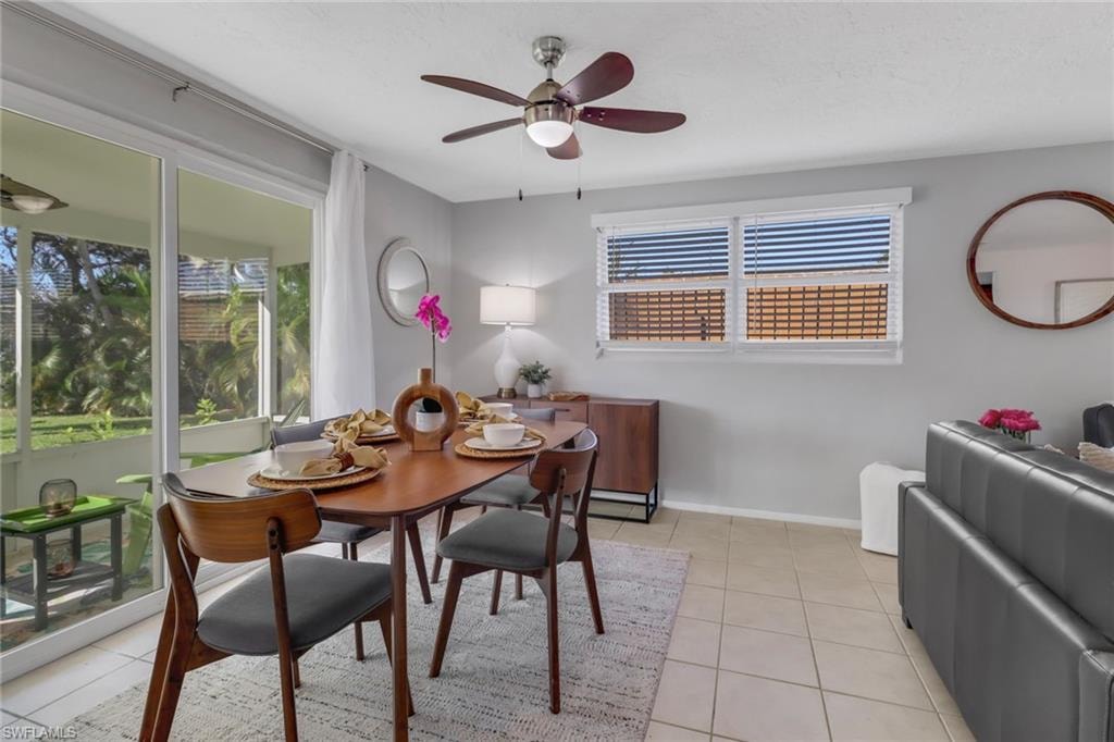 Dining space with ceiling fan and light tile patterned floors