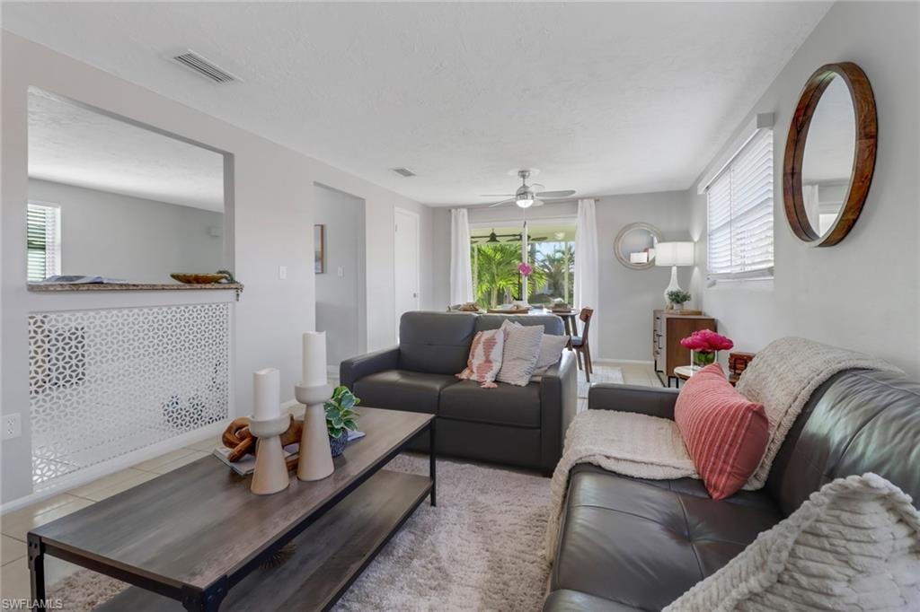 Tiled living room featuring ceiling fan