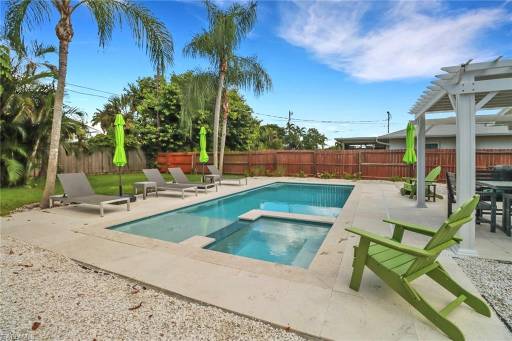 View of pool with a patio, a pergola, and an in ground hot tub