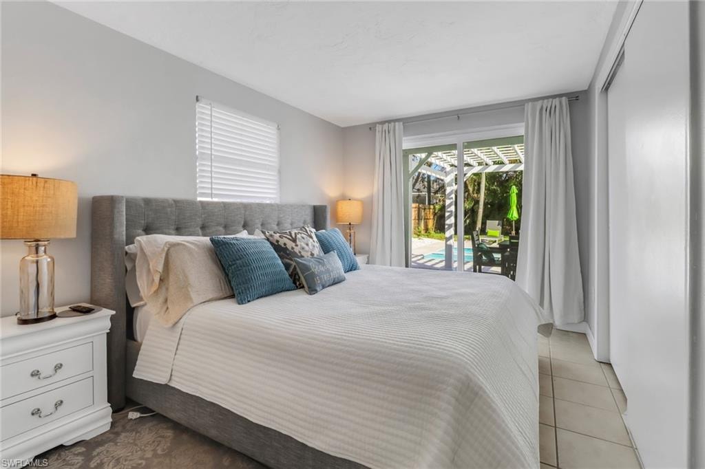 Tiled bedroom featuring access to exterior