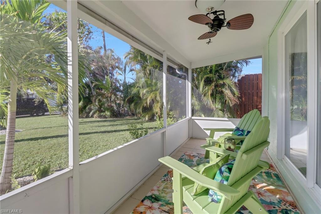 Sunroom featuring ceiling fan and a wealth of natural light