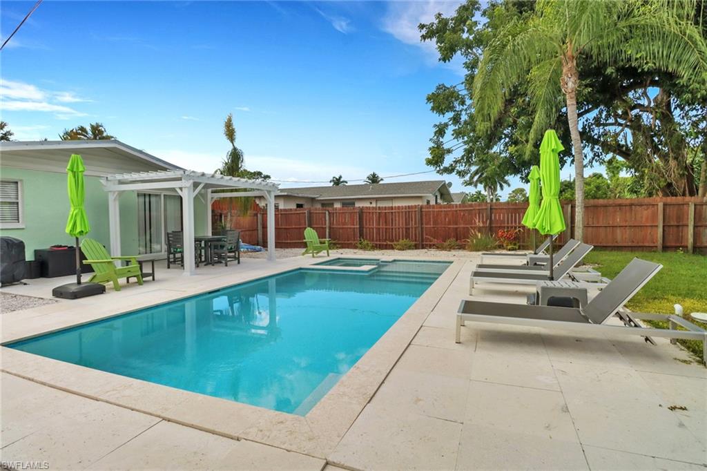 View of swimming pool with a pergola and a patio area