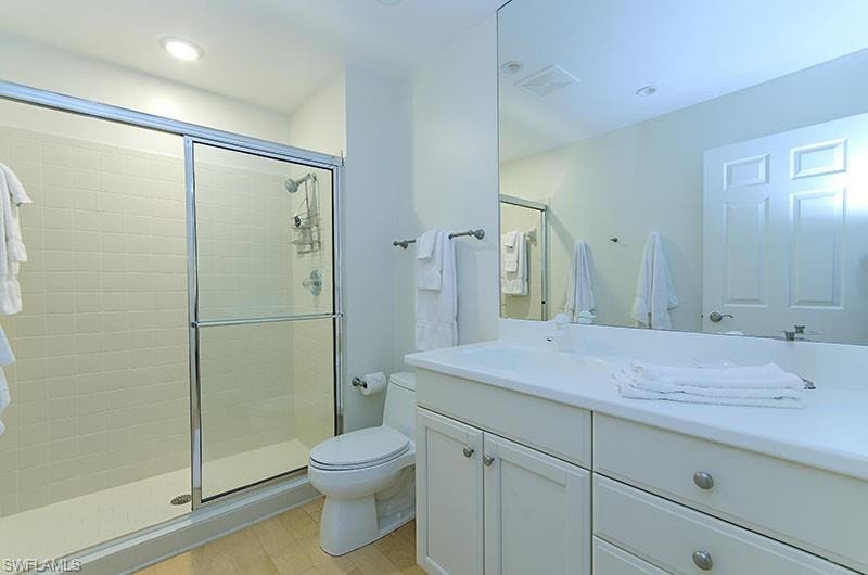 Full bathroom featuring vanity, a stall shower, and recessed lighting