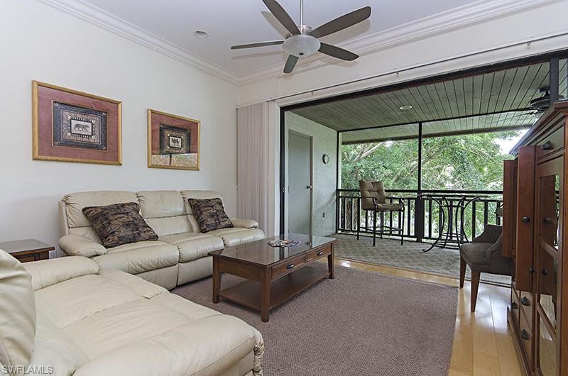 Living room featuring ornamental molding and light wood-style flooring