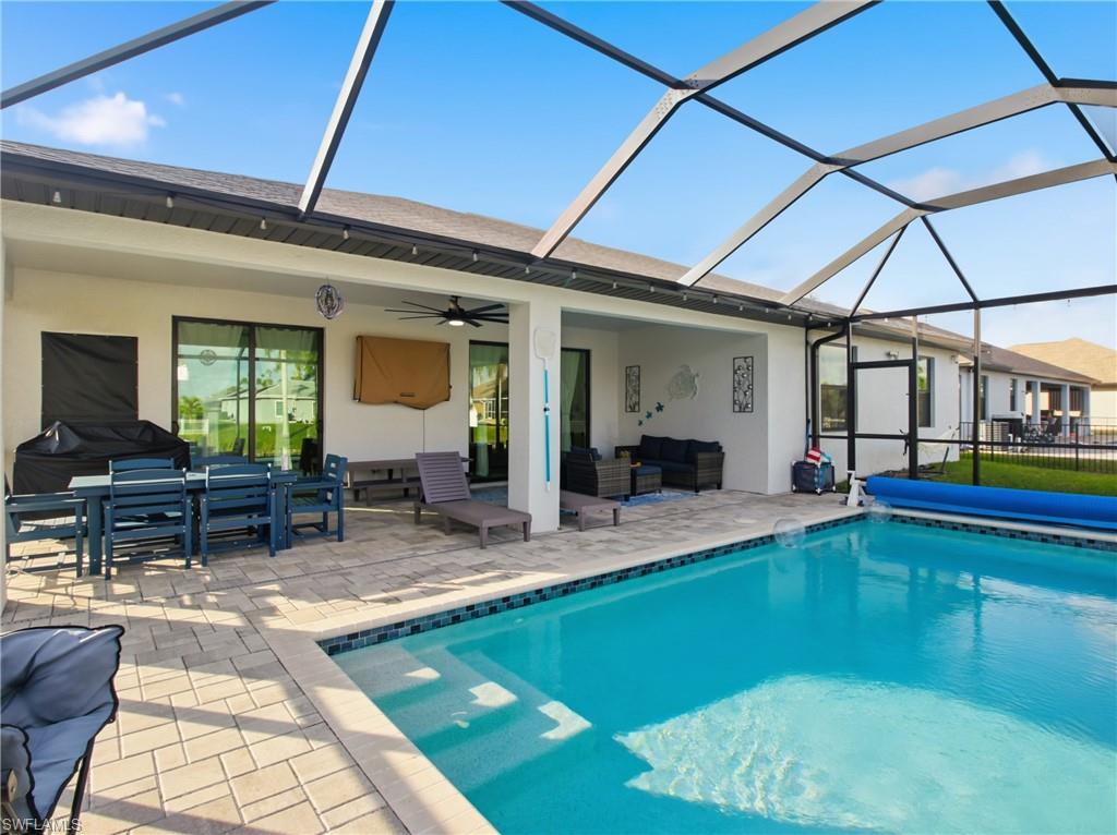 View of swimming pool with a covered pool, an outdoor hangout area, and a patio area