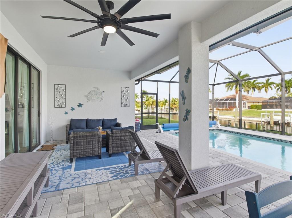 Swimming pool featuring a patio, an outdoor hangout area, a sunroom, and a screened enclosure