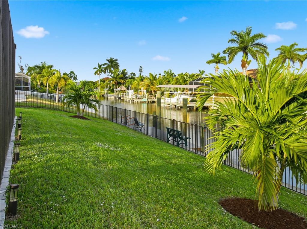 Fenced backyard featuring a water view