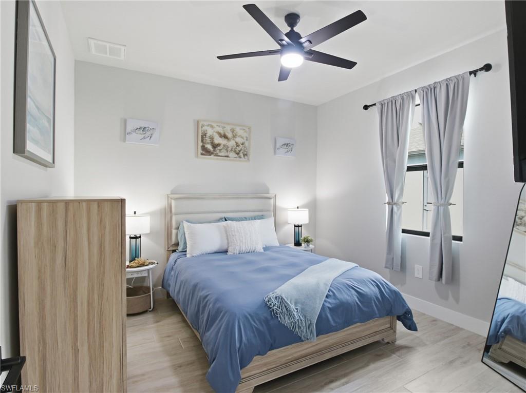Bedroom featuring light flooring and a ceiling fan