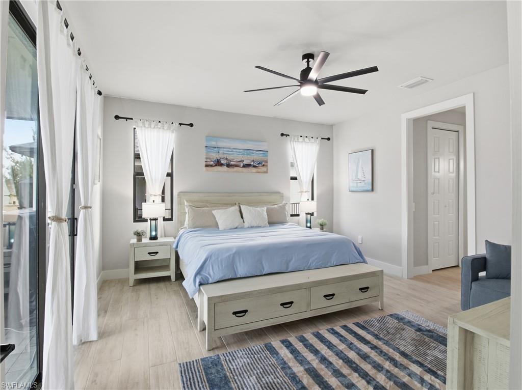 Bedroom featuring access to outside, light finished floors, and ceiling fan
