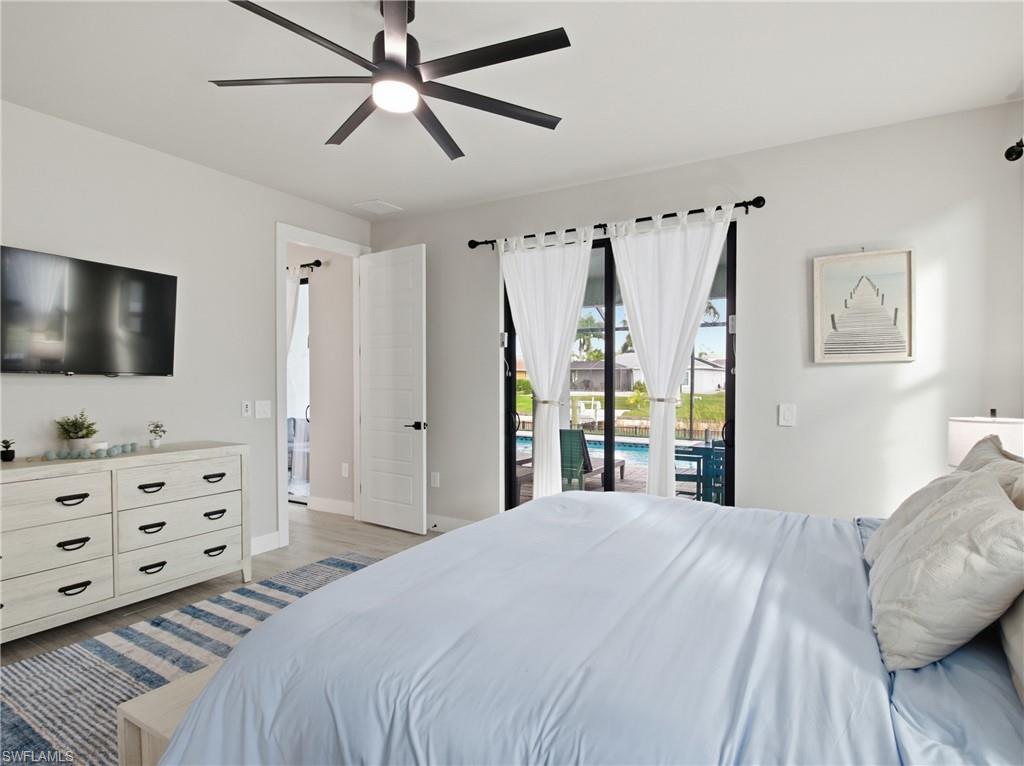 Bedroom featuring access to exterior, ceiling fan, and light flooring