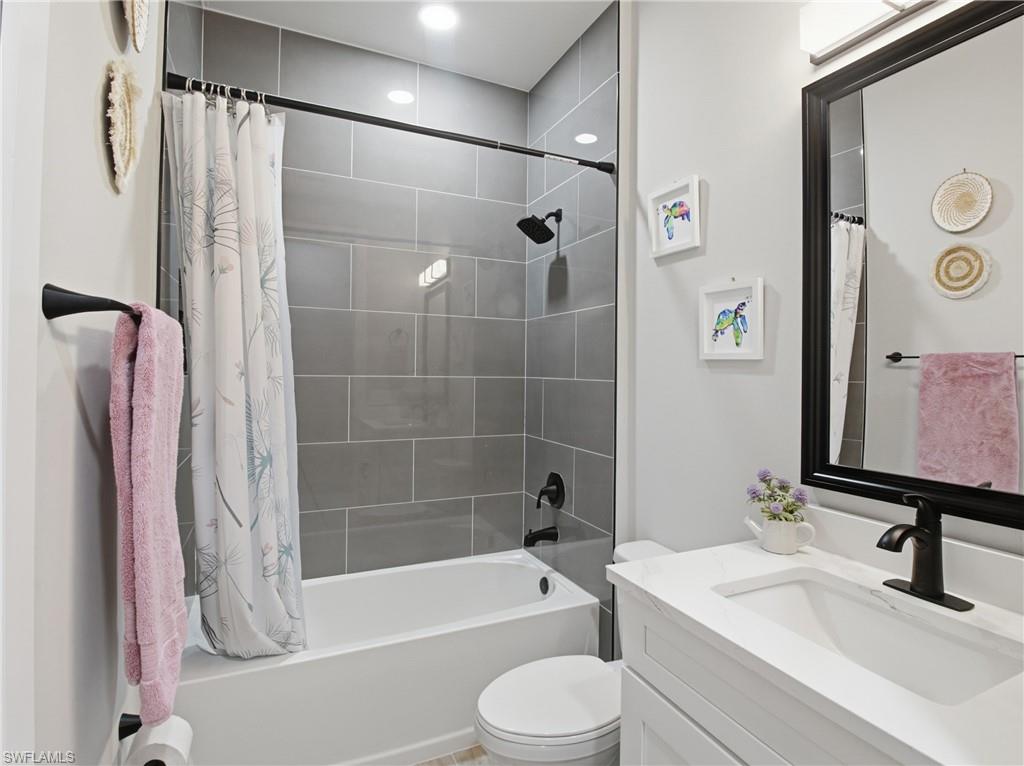 Full bath featuring vanity and shower / bath combo