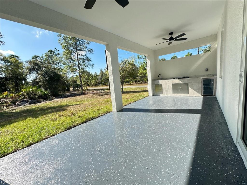 View of patio / terrace with area for grilling and a ceiling fan