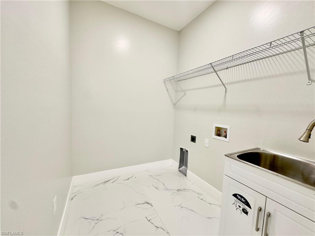 Laundry area featuring light marble finish flooring, electric dryer hookup, and hookup for a washing machine