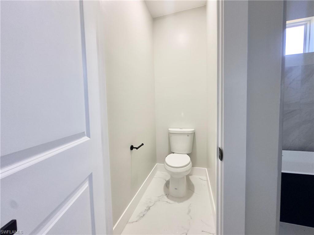 Bathroom with marble finish flooring and baseboards