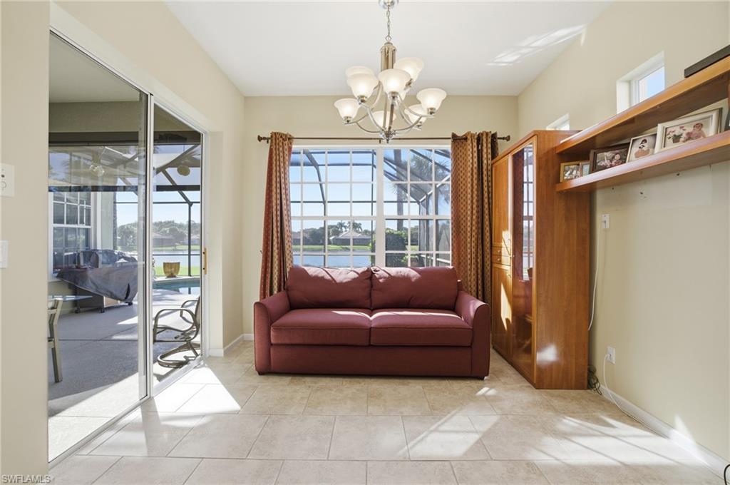 Sitting room with a water view, light tile patterned floors, a chandelier, and a sunroom