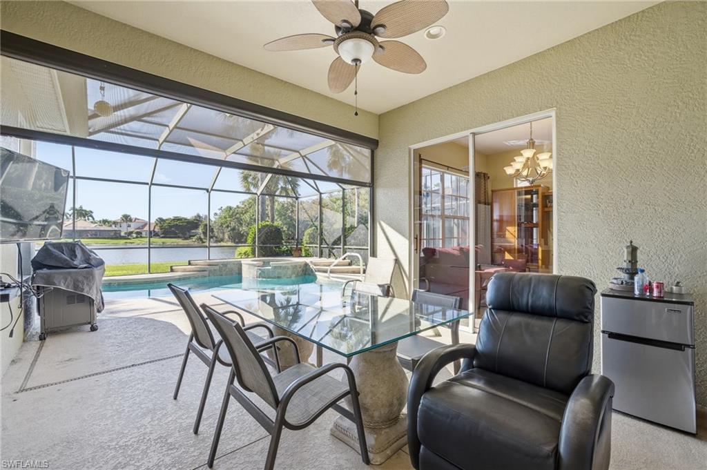 View of patio / terrace featuring a lanai, a sunroom, a water view, and ceiling fan