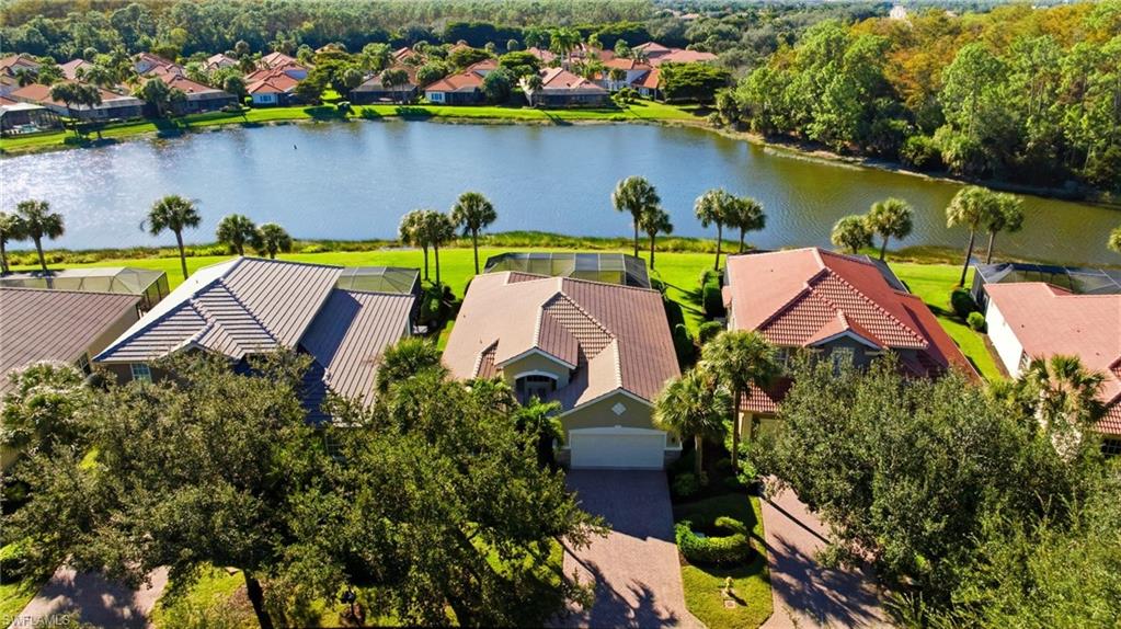 Aerial view of residential area featuring a nearby body of water