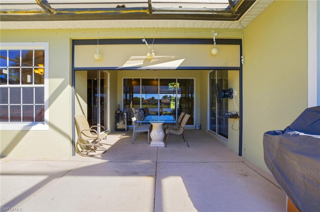 View of patio with a ceiling fan and outdoor dining area